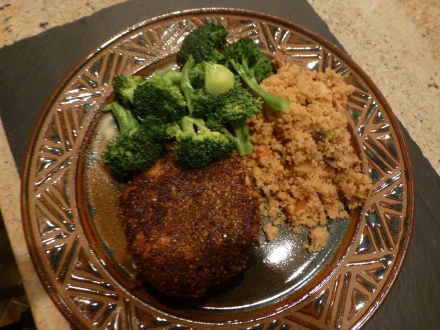 Chicken breast with a dukkah coating accompanied by whole wheat couscous with aromatic vegetables and steamed broccoli