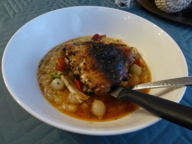 Chicken thigh with cacciatore sauce over polenta