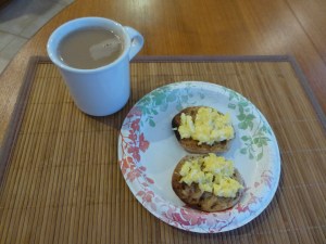 One egg scrambled on a light multi-grain English muffin and a cup of tea