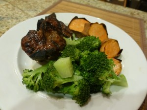 Grilled lamb chops, roasted sweet potato, and steamed broccoli
