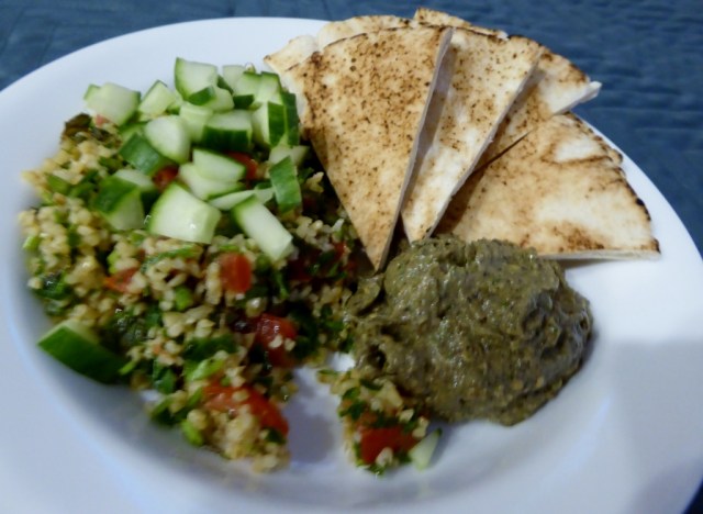 (Sorry for the blurriness) Tabbouleh topped with chopped cucumbers, baba ganoush and pita