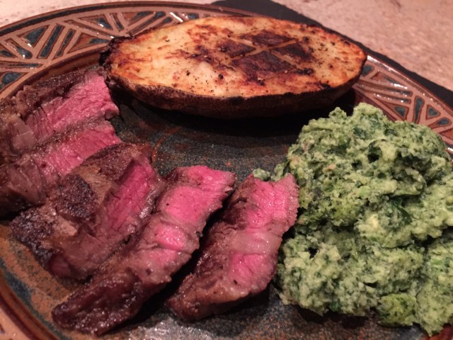 Ribeye steak with grilled potato and spinach
