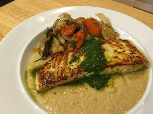 Pan-seared halibut with parsley sauce, a purée of chickpeas and braised carrots, onions, and fennel