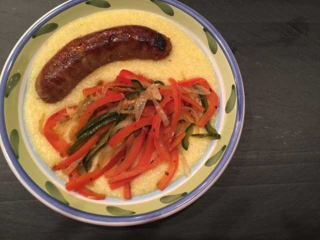 Sausage with peppers and onions over polenta