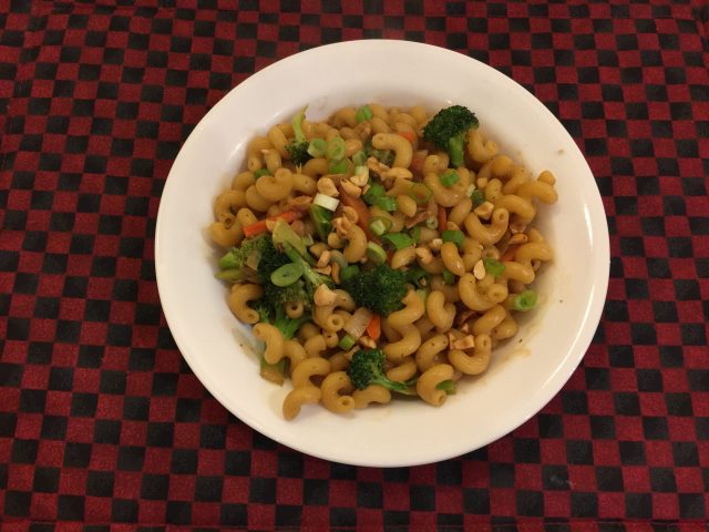 Cellentani with broccoli and carrots in peanut sauce