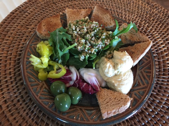 Hummus, tabbouleh, salad, toast points, olives, and pepperoncini 