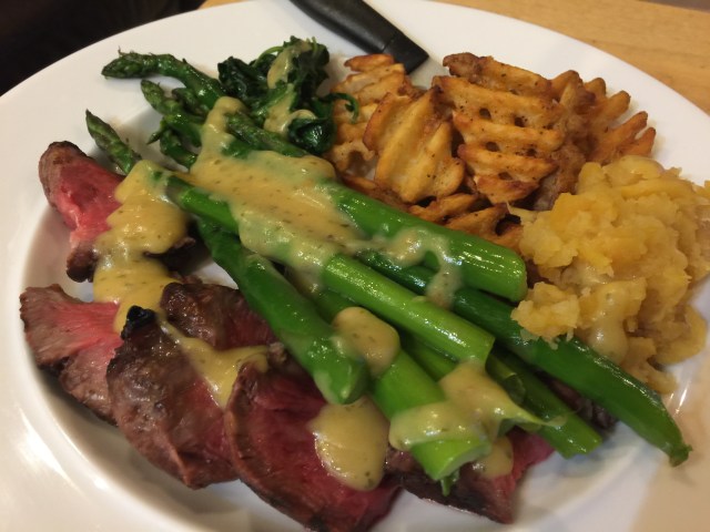 Steak, waffle fries, rutabagas, asparagus, kale, and bernaise