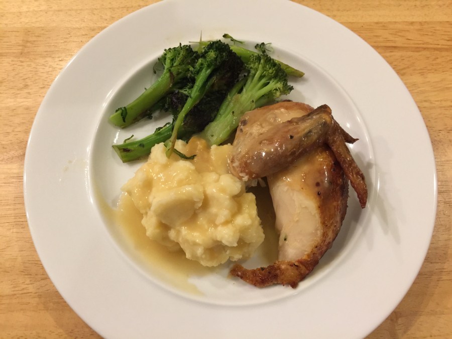 Chicken breast with wing, mashed potatoes, and broccoli